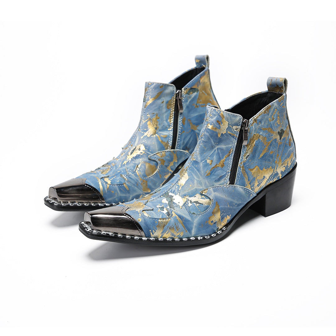 Pair of men's blue and gold splatter ankle boots with shiny metal toe caps and side zippers on a white background.