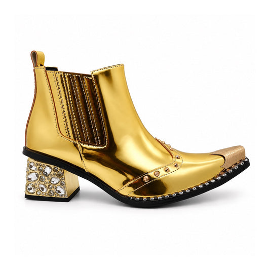 Pair of Aomishoes metallic gold studded ankle boots with pointed metal toe caps and rhinestone embellished block heels on a