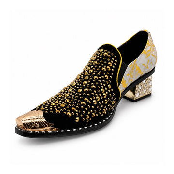 A pair of men's black studded loafers with a gold metal toe cap, a gold and grey patterned upper, and a crystal-embellished