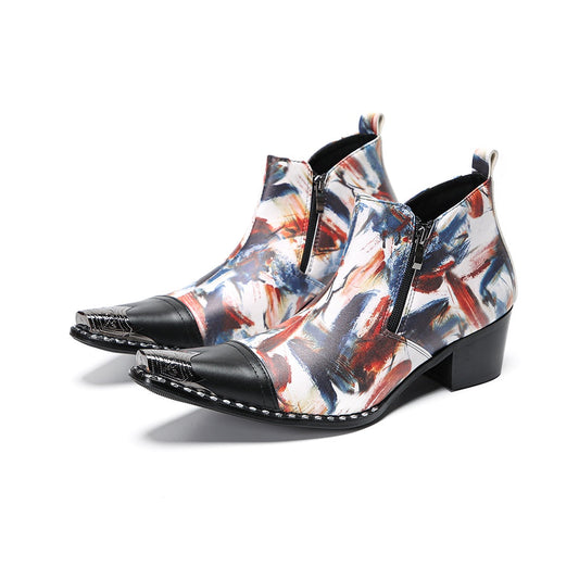Pair of men's abstract print ankle boots with black leather pointed toe and metal tip, side zippers, and black block heels.