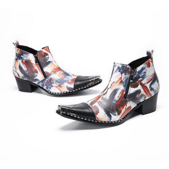 Pair of men's abstract print ankle boots with black leather pointed toe and metal tip, side zippers, and black block heels.