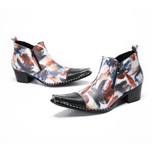 Pair of men's abstract print ankle boots with black leather pointed toe and metal tip, side zippers, and black block heels.
