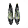 A pair of men's green and black patterned ankle boots with pointed metal toes and side zippers.