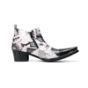 A pair of men's black and white newspaper print ankle boots with a pointed metal toe, side zipper, and block heel.