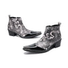 Pair of men's black and white newspaper print ankle boots with patent leather pointed toes and studded details.