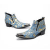 Pair of men's blue and gold splatter ankle boots with shiny metal toe caps and side zippers on a white background.