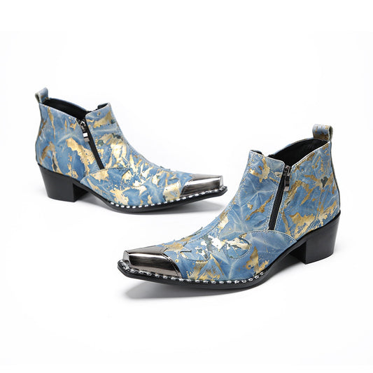 Pair of men's blue and gold splatter ankle boots with shiny metal toe caps and side zippers on a white background.