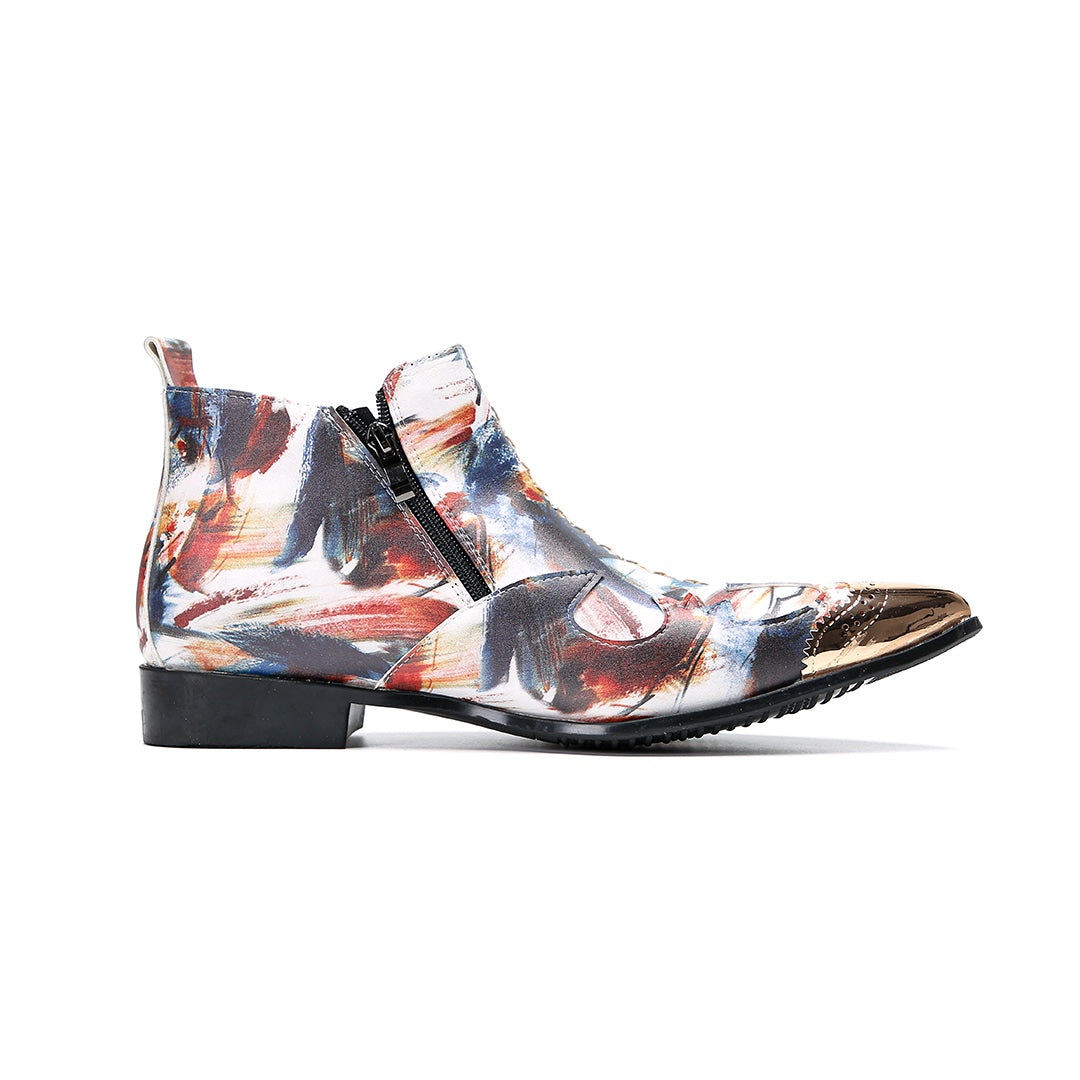 A pair of men's abstract print ankle boots with a gold metal cap toe and side zipper, shown against a white background.