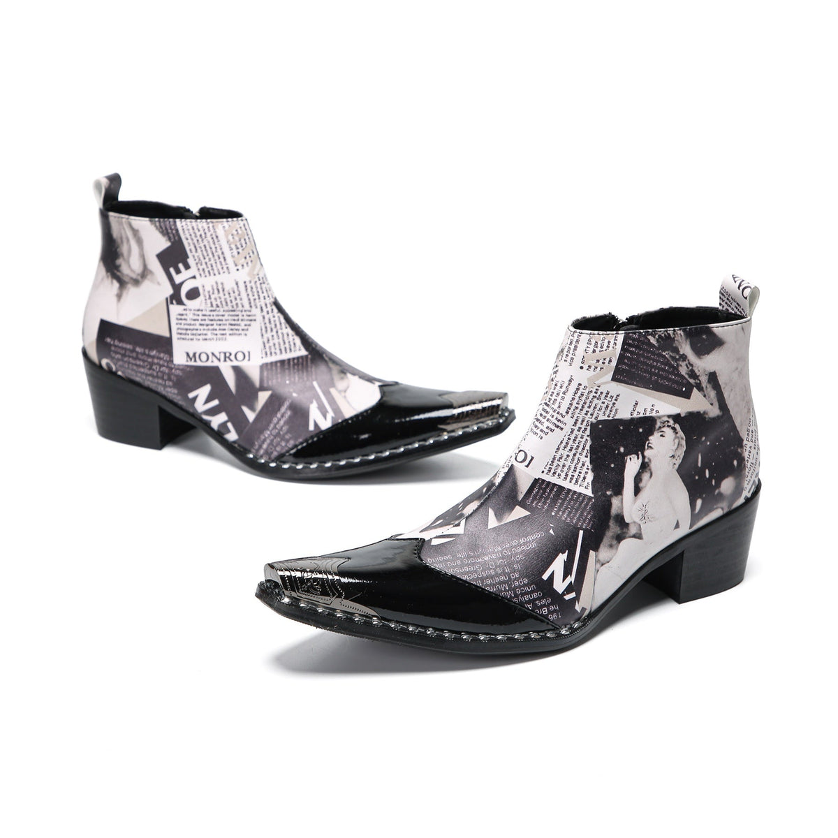 Pair of Aomishoes men's newspaper print ankle boots with pointed patent leather toe caps and side zippers on a white