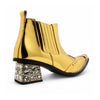 Pair of Aomishoes metallic gold studded ankle boots with pointed metal toe caps and rhinestone embellished block heels on a