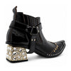 Black patent leather men's pointed toe ankle boot with metal toe cap, studded details, and a gold rhinestone-embellished