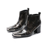 Pair of shiny black square toe ankle boots with metal tip and block heels