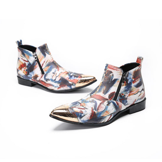 A pair of men's abstract print ankle boots with a gold metal cap toe and side zipper, shown against a white background.