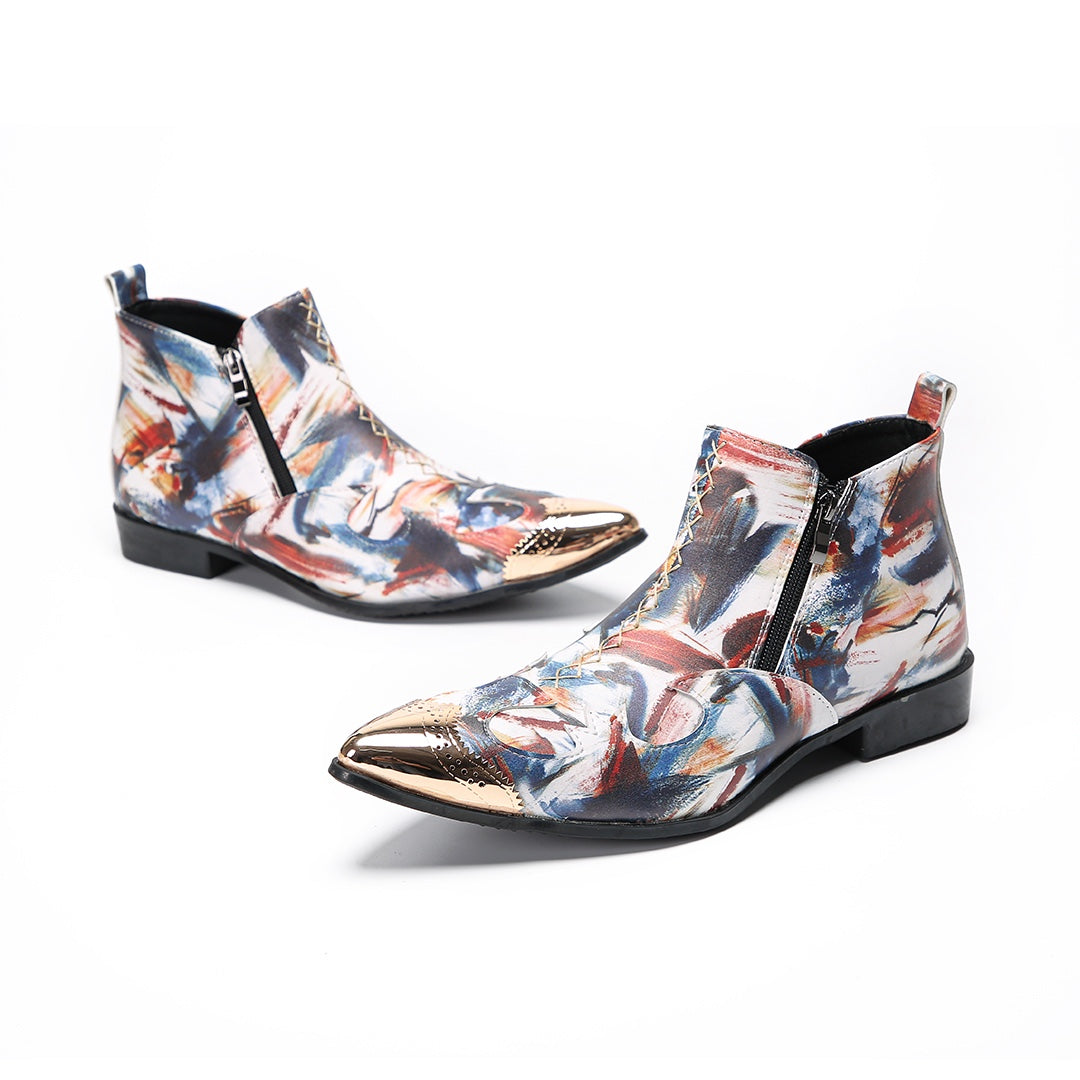 A pair of men's abstract print ankle boots with a gold metal cap toe and side zipper, shown against a white background.