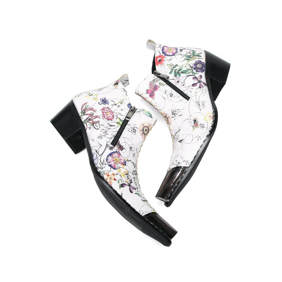 Pair of men's white genuine leather ankle boots with a colorful floral print and shiny metallic pointed toe caps.