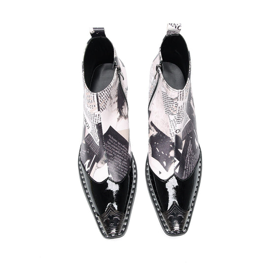 Pair of Aomishoes men's newspaper print ankle boots with pointed patent leather toe caps and side zippers on a white