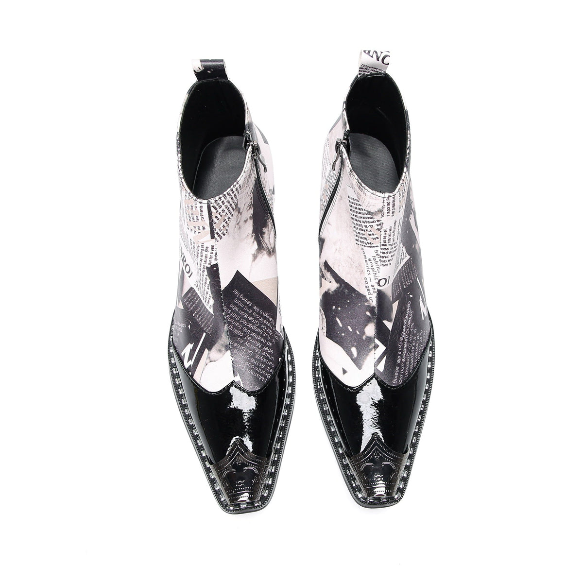 Pair of Aomishoes men's newspaper print ankle boots with pointed patent leather toe caps and side zippers on a white
