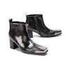 Pair of shiny black square toe ankle boots with metal tip and block heels