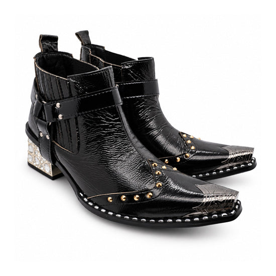 Black patent leather men's pointed toe ankle boot with metal toe cap, studded details, and a gold rhinestone-embellished