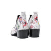 Pair of men's white genuine leather ankle boots with a colorful floral print and shiny metallic pointed toe caps.