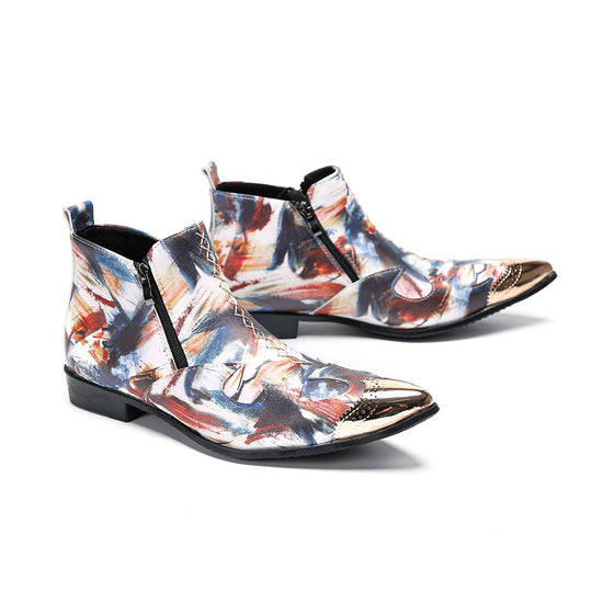 A pair of men's abstract print ankle boots with a gold metal cap toe and side zipper, shown against a white background.