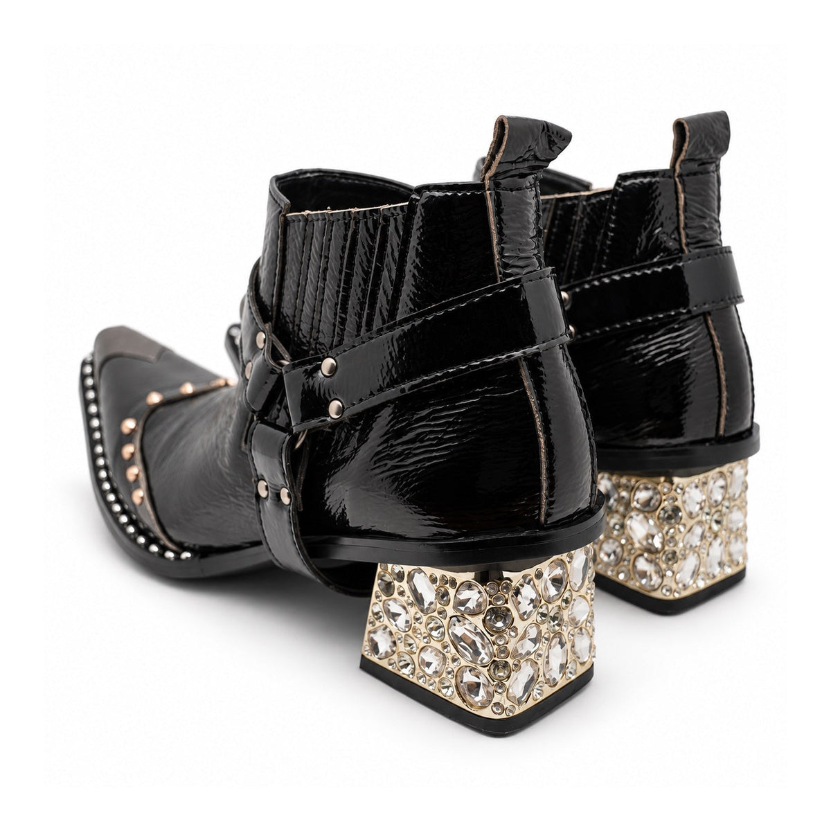 Black patent leather men's pointed toe ankle boot with metal toe cap, studded details, and a gold rhinestone-embellished