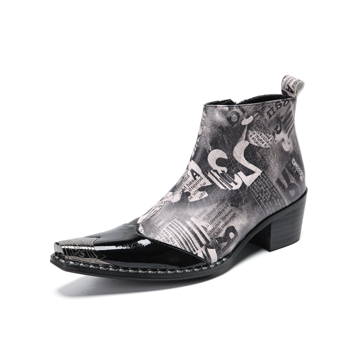 Pair of men's black and white newspaper print ankle boots with patent leather pointed toes and studded details.