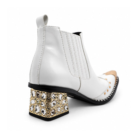 A pair of Aomishoes white genuine leather Chelsea boots with a gold metal pointed toe, gold studs, and a