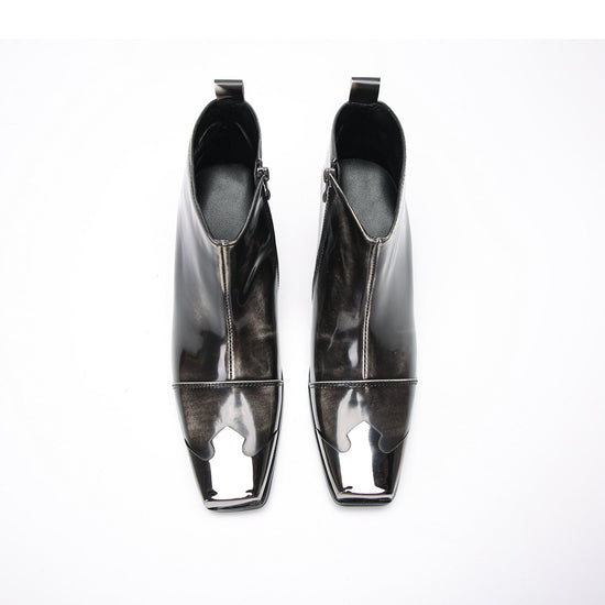 Pair of shiny black square toe ankle boots with metal tip and block heels