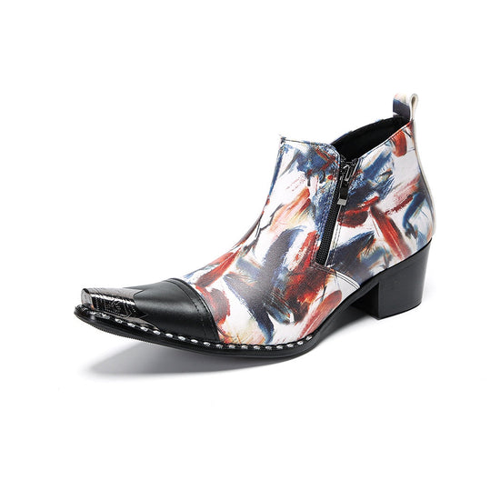 Pair of men's abstract print ankle boots with black leather pointed toe and metal tip, side zippers, and black block heels.