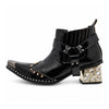 Black patent leather men's pointed toe ankle boot with metal toe cap, studded details, and a gold rhinestone-embellished