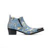 Pair of men's blue and gold splatter ankle boots with shiny metal toe caps and side zippers on a white background.
