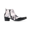Pair of Aomishoes men's newspaper print ankle boots with pointed patent leather toe caps and side zippers on a white