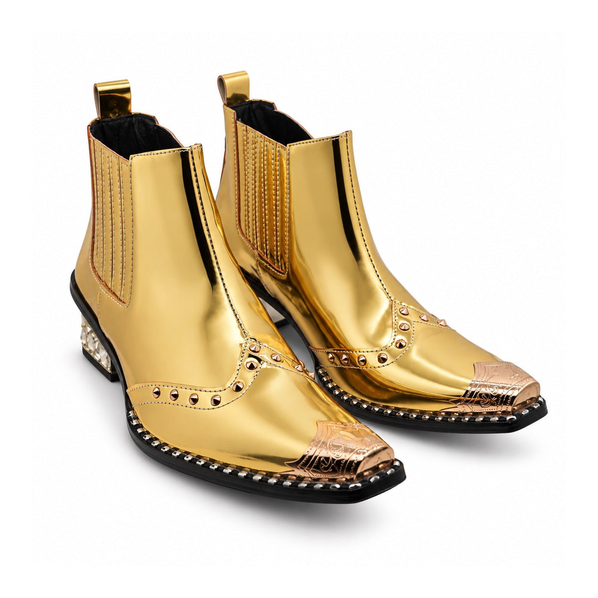 Pair of Aomishoes metallic gold studded ankle boots with pointed metal toe caps and rhinestone embellished block heels on a