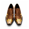 A pair of men's metallic gold and bronze slip-on western dress shoes with a pointed metal toe and a rhinestone-studded block