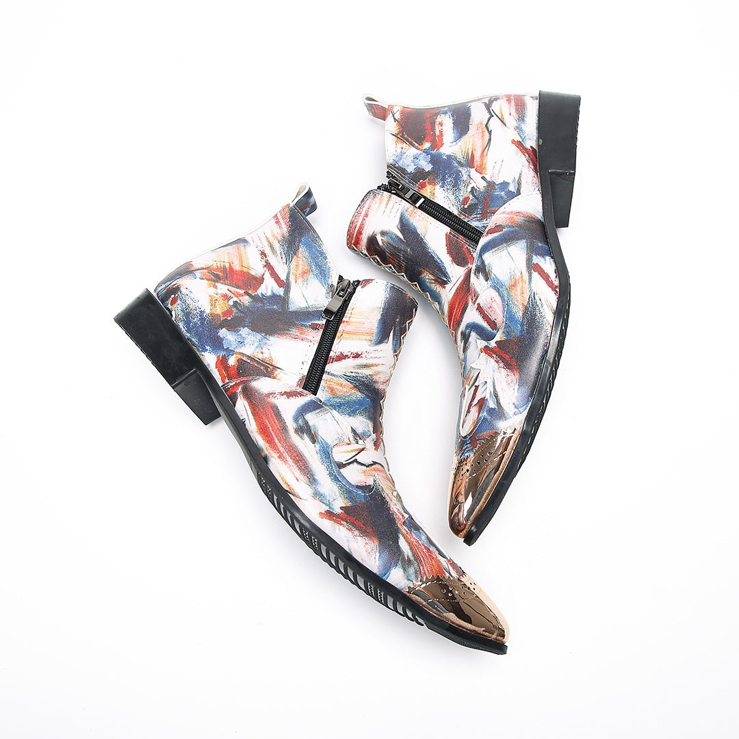 A pair of men's abstract print ankle boots with a gold metal cap toe and side zipper, shown against a white background.