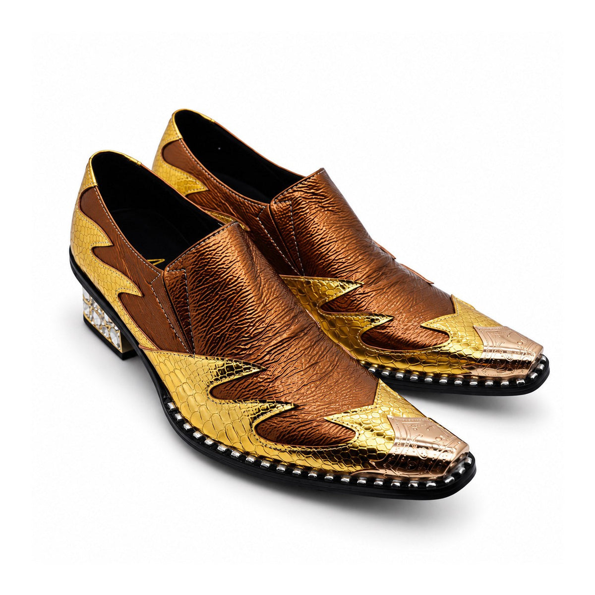 A pair of men's metallic gold and bronze slip-on western dress shoes with a pointed metal toe and a rhinestone-studded block