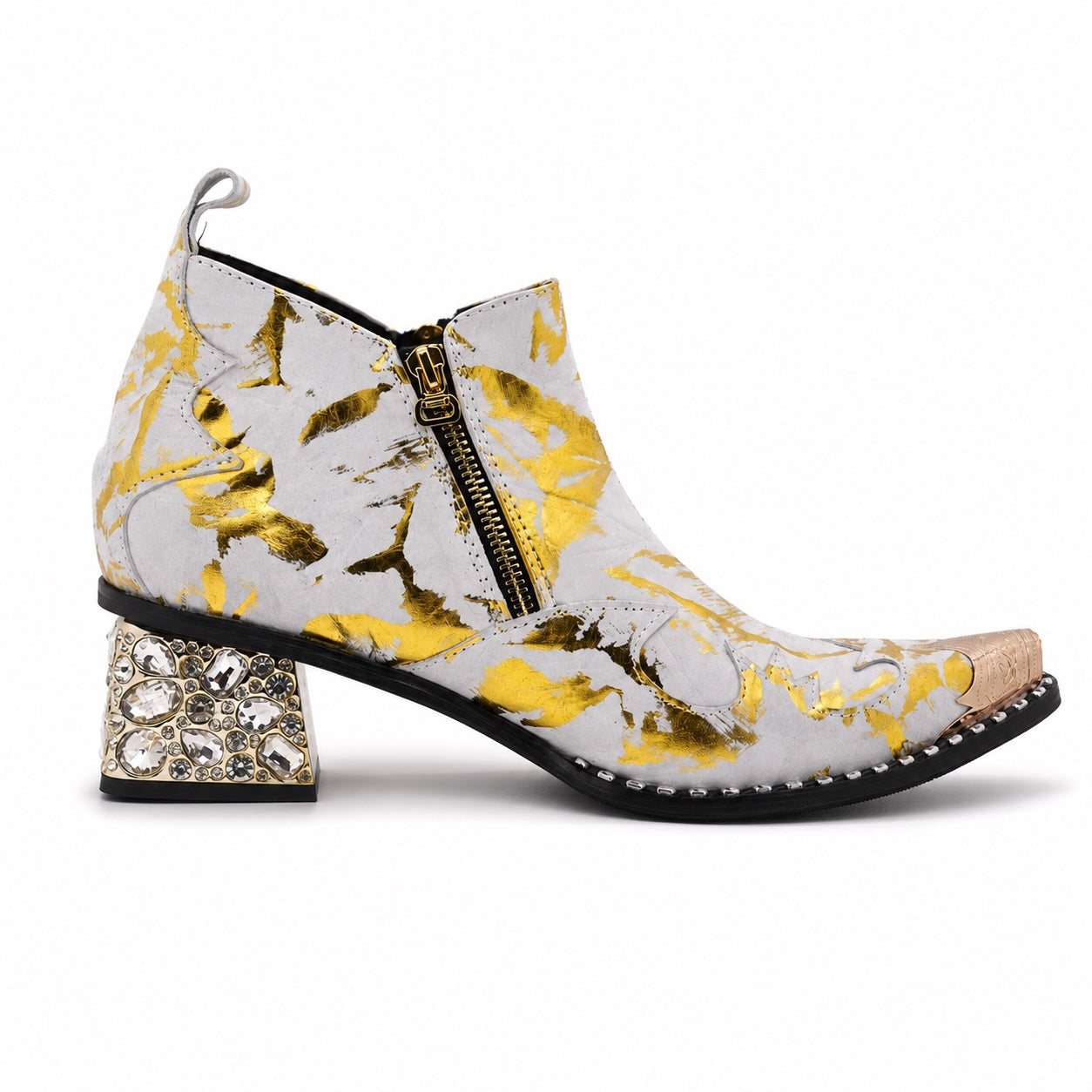 White and gold foil patterned ankle boot with a pointed metal toe, side zipper, and a block heel embellished with clear