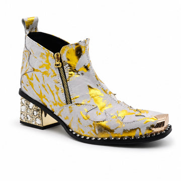 White and gold foil patterned ankle boot with a pointed metal toe, side zipper, and a block heel embellished with clear