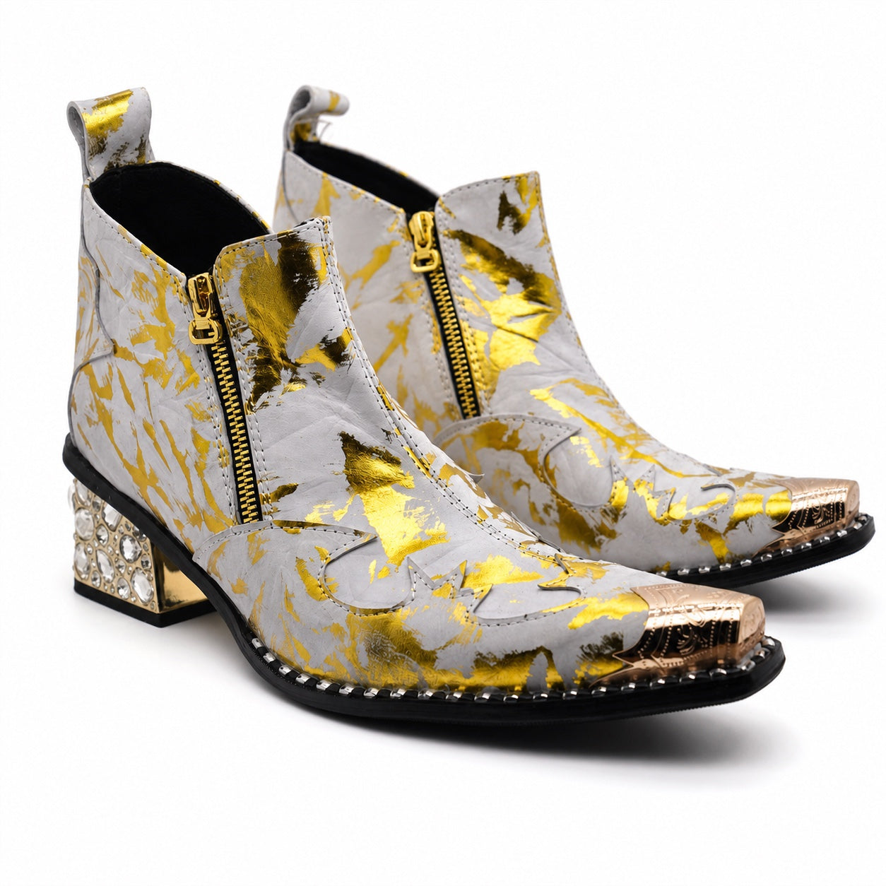 White and gold foil patterned ankle boot with a pointed metal toe, side zipper, and a block heel embellished with clear